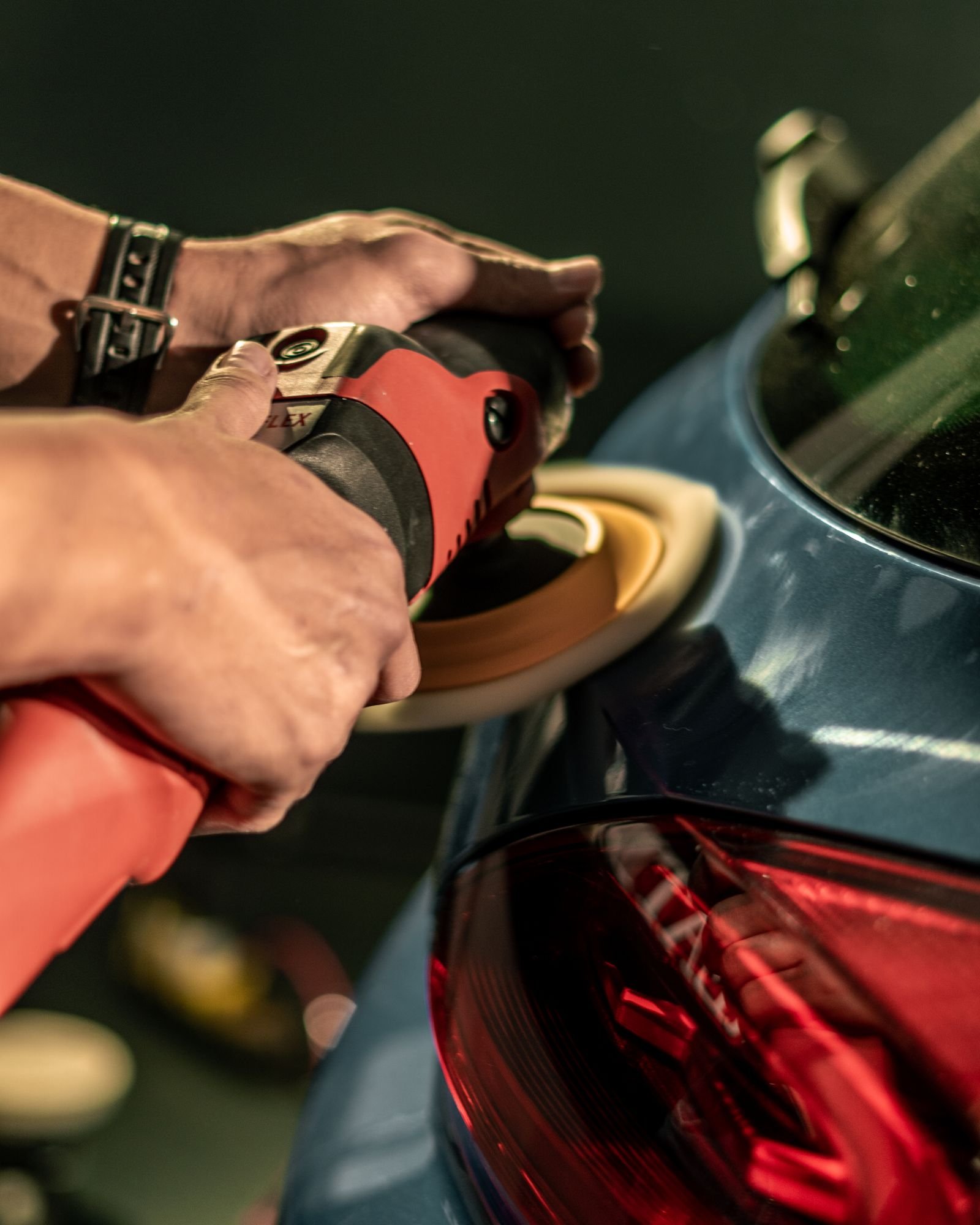 Detailing specialist polishing a car body panel